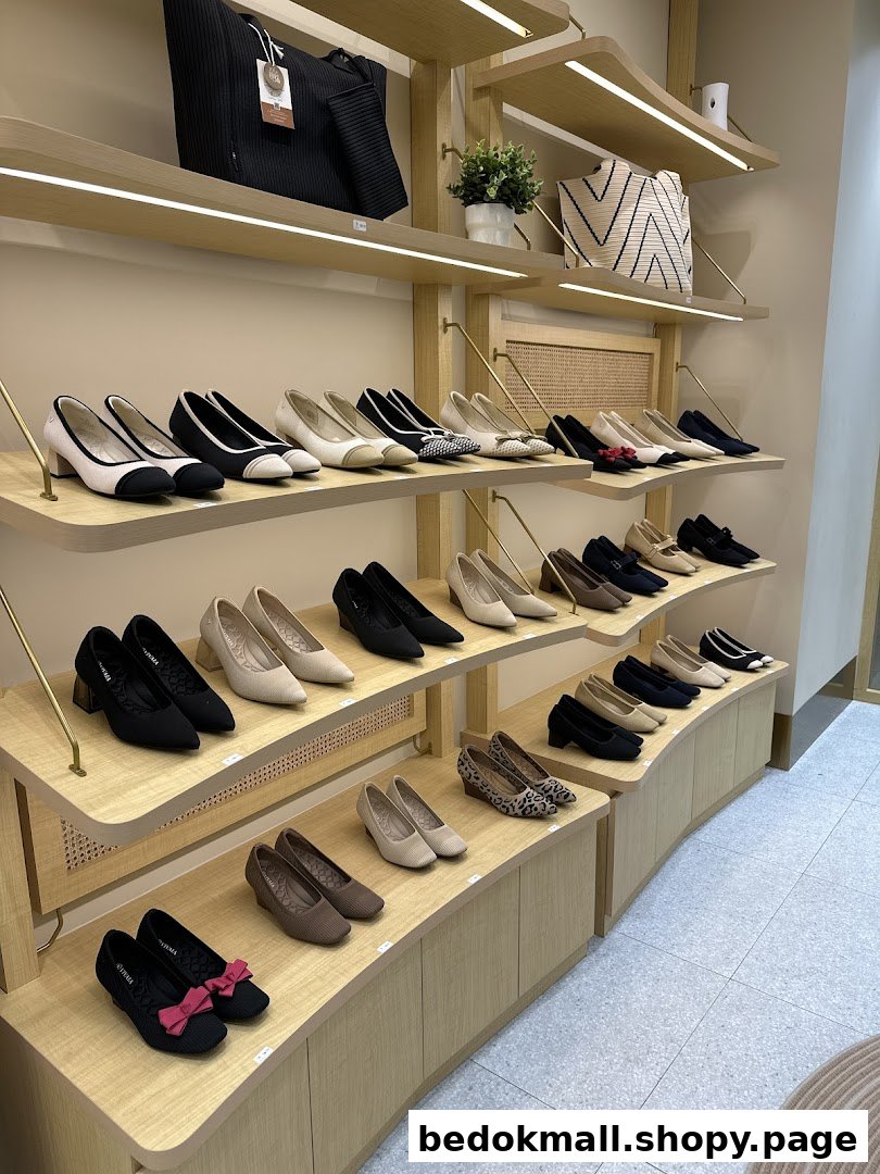 Interior view of a shoe shop with various shoes and bags on display shelves.