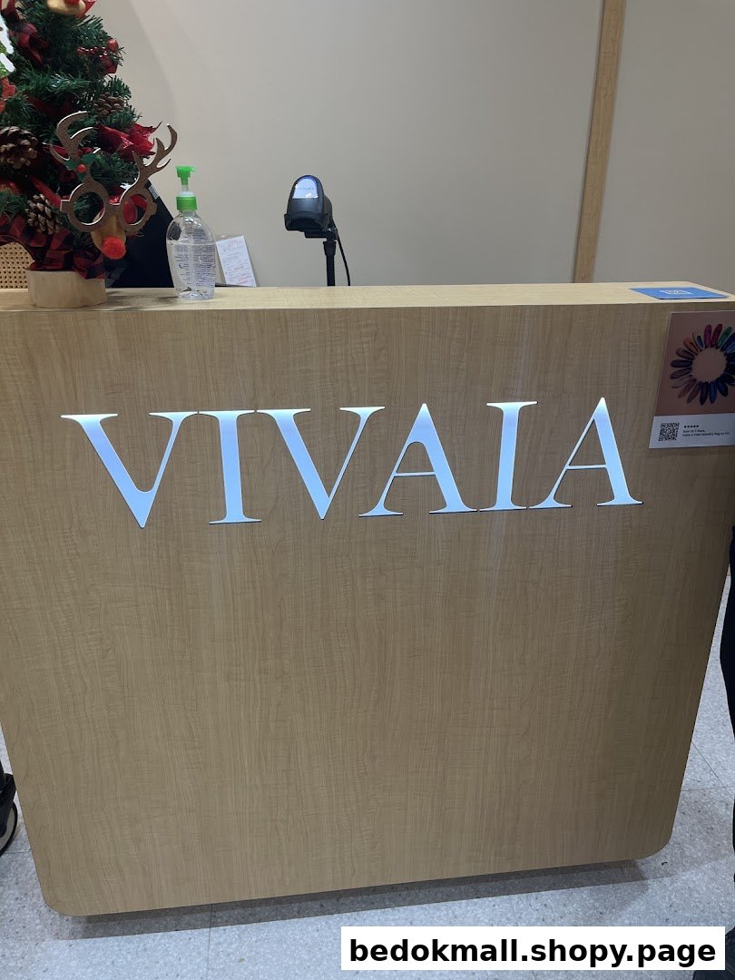 A wooden counter with the VIVAIA logo, scanner, and Christmas decor.
