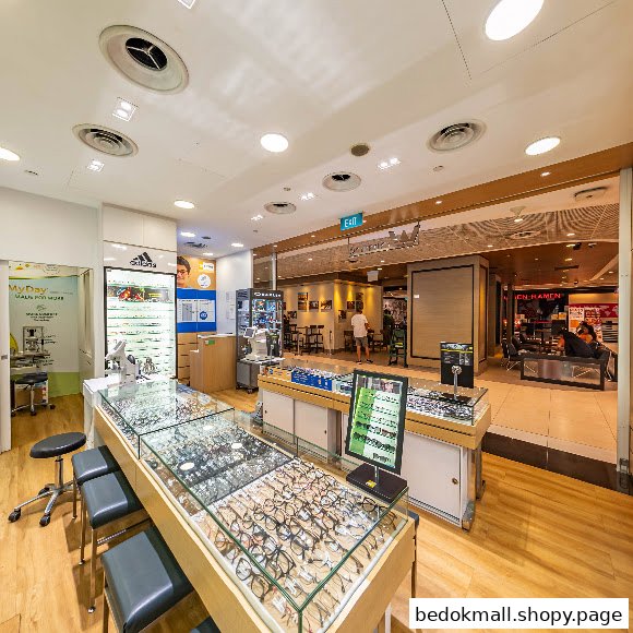 Interior view of an optics shop with display cases of eyeglasses.