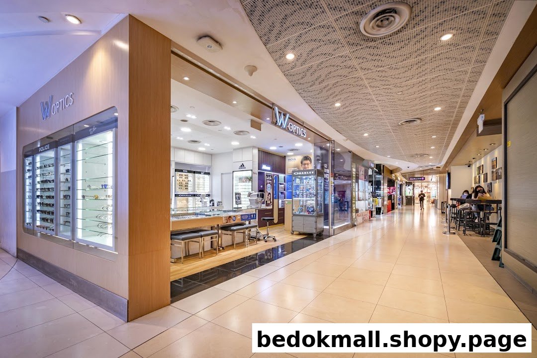 Exterior view of W Optics shop in a mall corridor with display windows.
