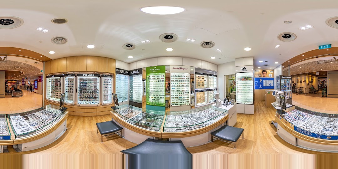 Interior view of an optical shop with display cases and examination equipment.
