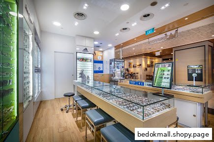 Interior view of an optical shop with display cases of eyeglasses.