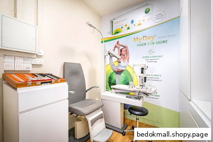 Eye examination room with optical equipment and contact lens display.