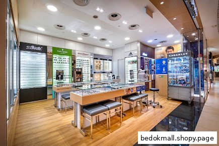 Interior view of an optical shop with eyewear displays and testing equipment.
