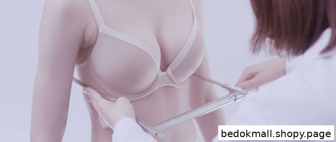 A person is being measured for a bra by a staff member.