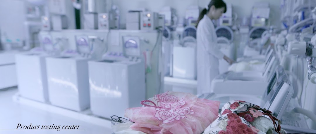 Interior of a product testing center with a person in a lab coat and machinery.