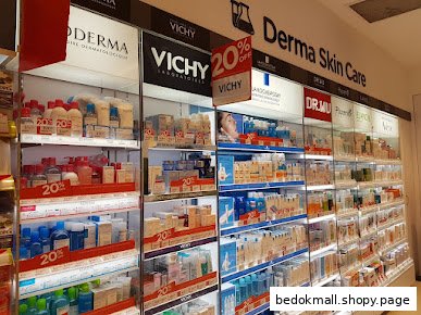Shelves filled with various skincare products and 'Derma Skin Care' signage inside a shop.