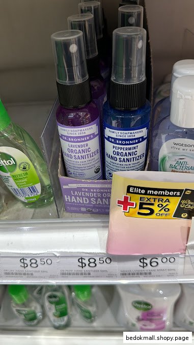 Hand sanitizers displayed on a retail shelf with price tags and a promotional sign.