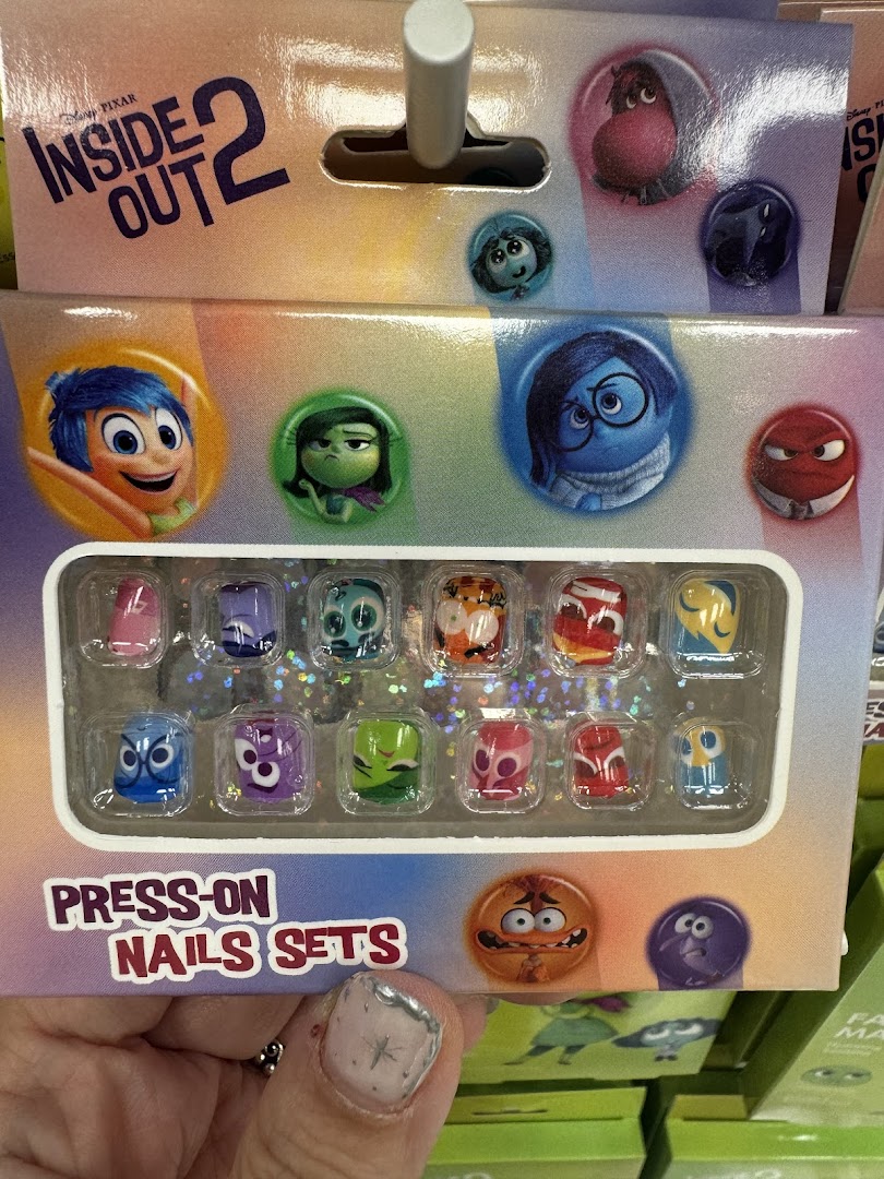 Close-up of Inside Out 2 press-on nails product packaging on a retail shelf.
