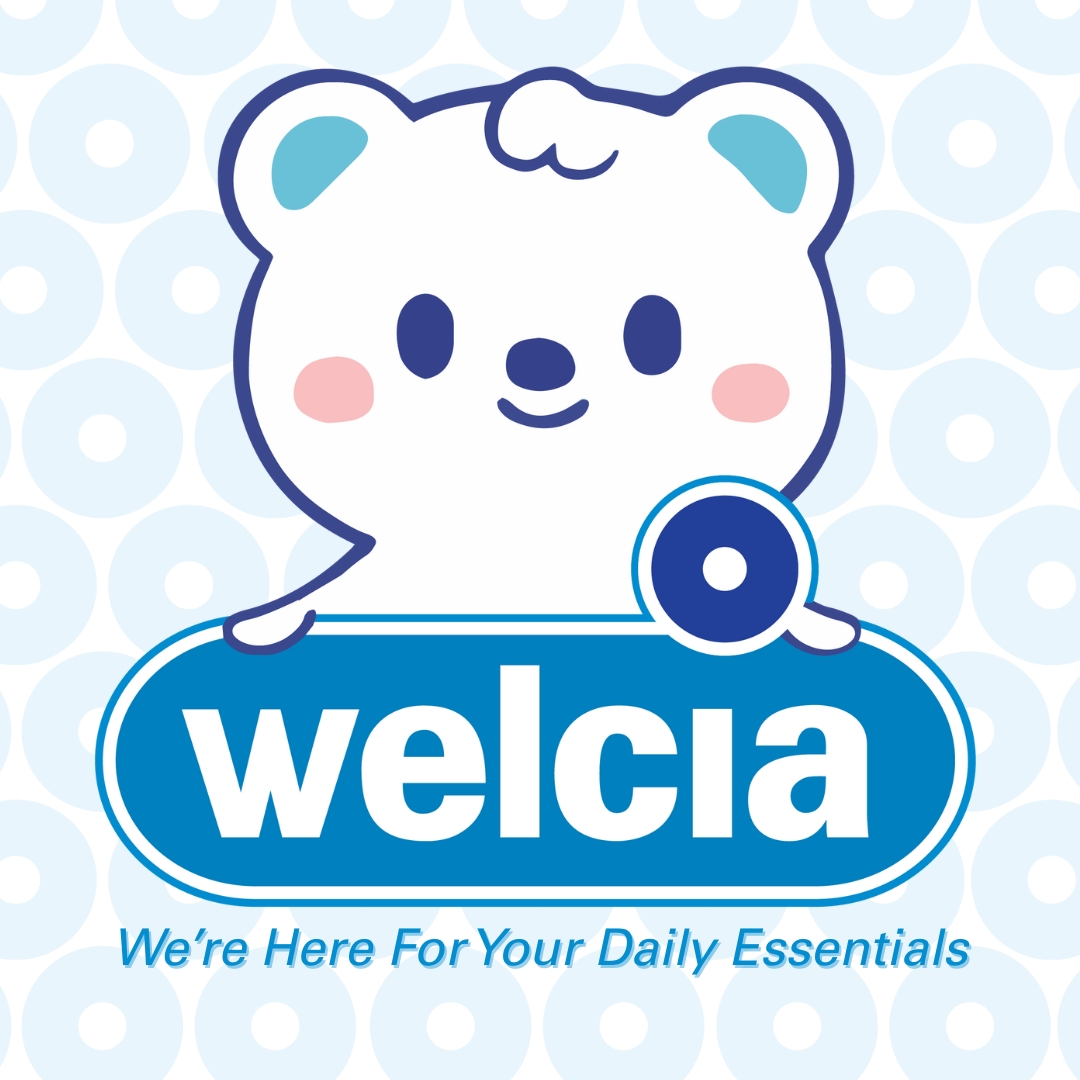 Cartoon bear logo for Welcia with slogan 'We're Here For Your Daily Essentials'.