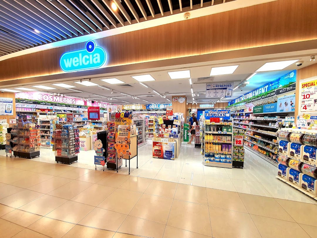 Entrance of a Welcia store with products and aisles visible inside.