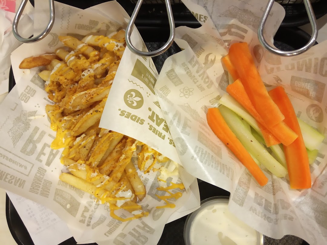 Cheesy fries, carrot and celery sticks with dip in branded containers.