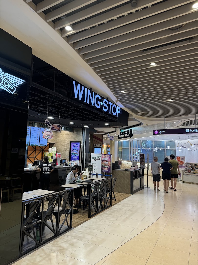 Wingstop shop front and entrance area with seating in a mall.