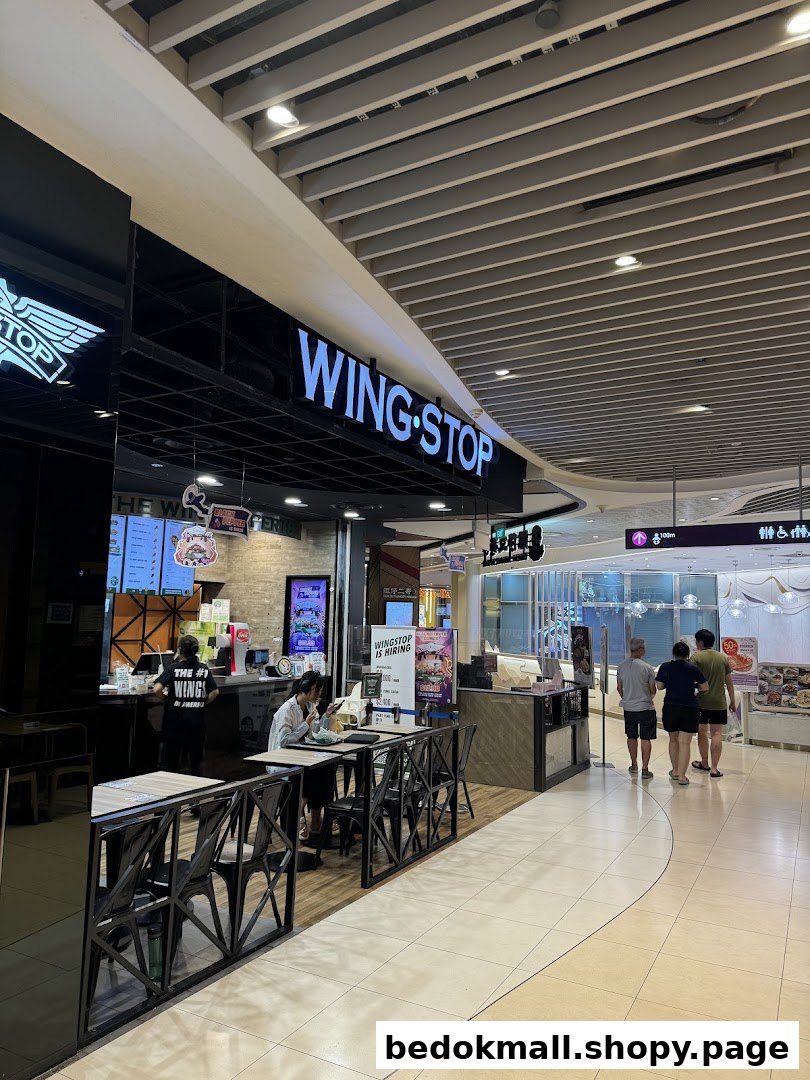 Wingstop shop front and entrance area with seating in a mall.