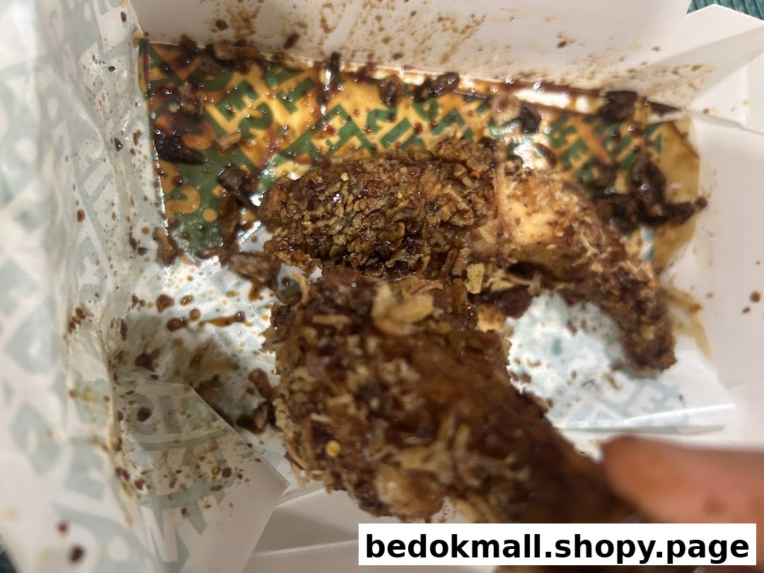 Sauced chicken wings in a Wingstop takeout box.