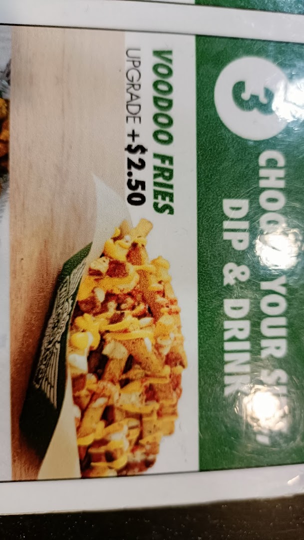 Close-up of a menu board showing Voodoo Fries with an upgrade price.