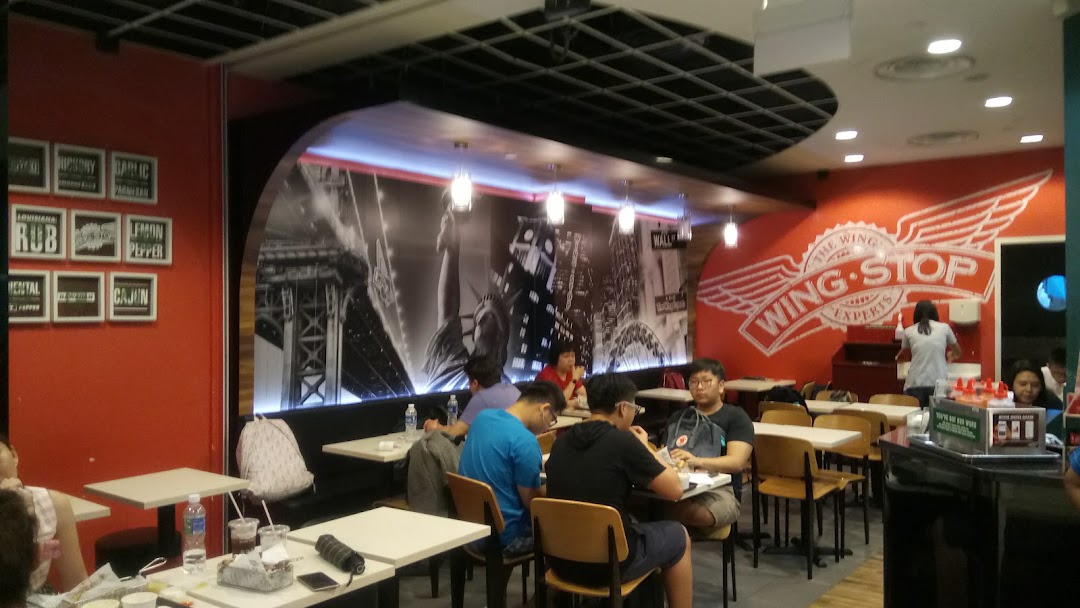 Interior view of a Wingstop restaurant with customers dining.