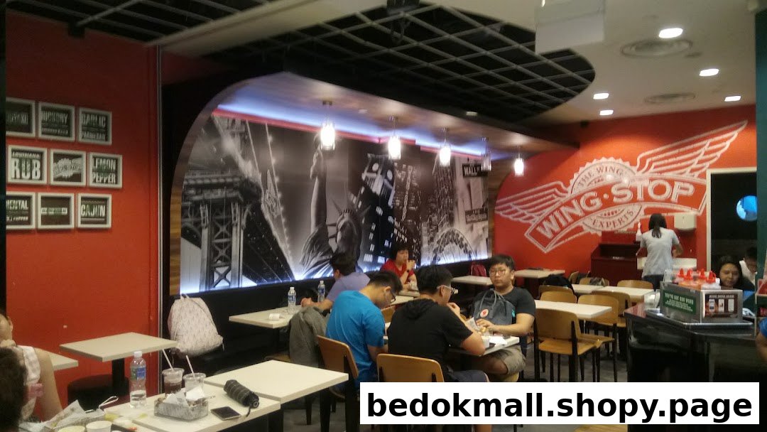 Interior view of a Wingstop restaurant with customers dining.