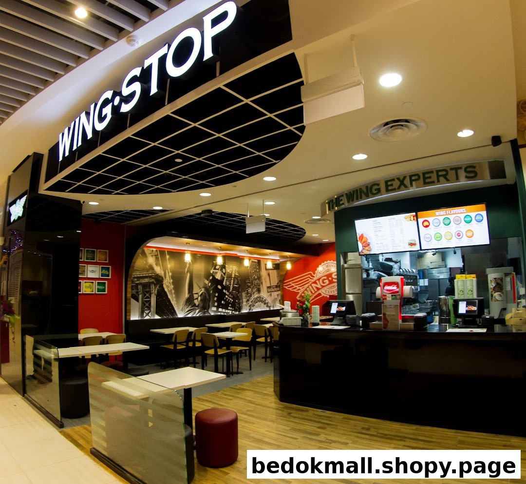 Interior view of Wingstop restaurant with counter, menu screens, and seating area.