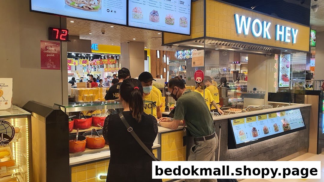 WOK HEY food stall interior with staff preparing food and serving customers.