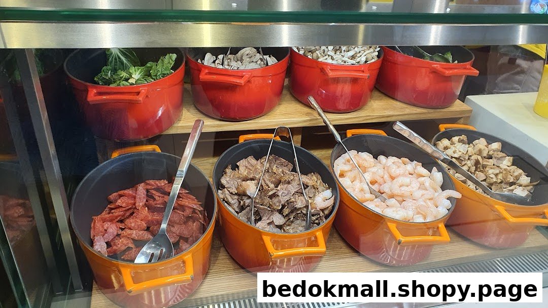 Various fresh ingredients in pots behind a glass counter.