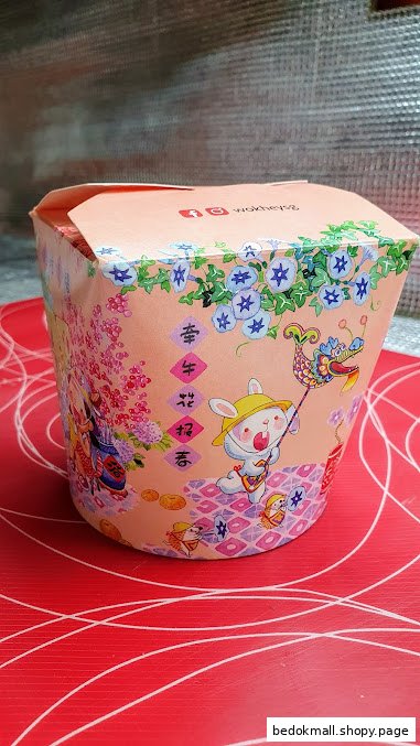 Close-up of a WOK HEY food container with a festive rabbit and floral design.
