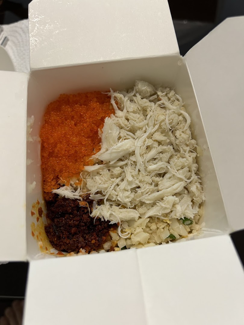 Takeaway box with rice, crab meat, roe, and chili paste.