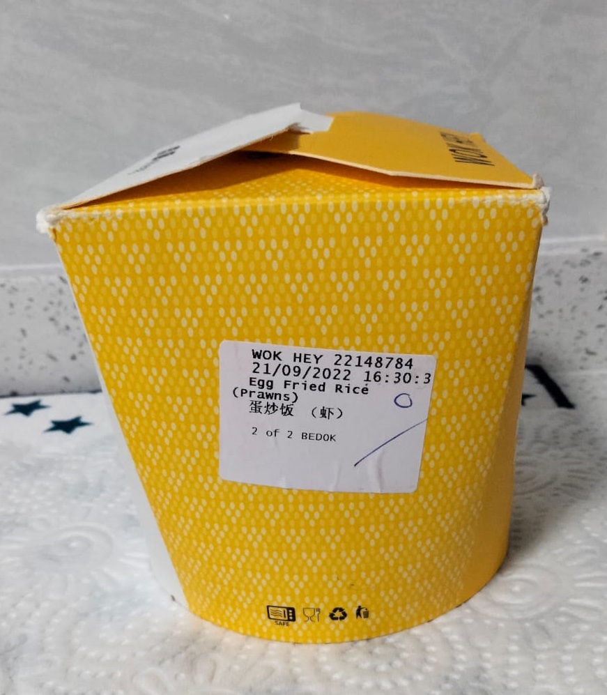 A yellow food container with a label for "Egg Fried Rice (Prawns)".