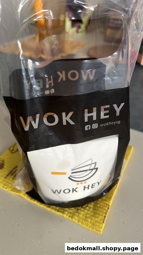 WOK HEY branded food container in a clear plastic bag on a counter.