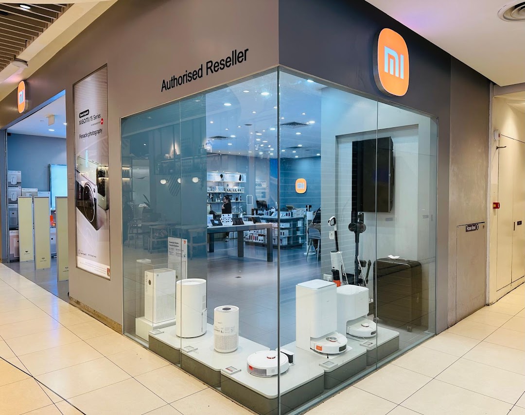 Exterior view of a Xiaomi Authorized Reseller shop with display windows.