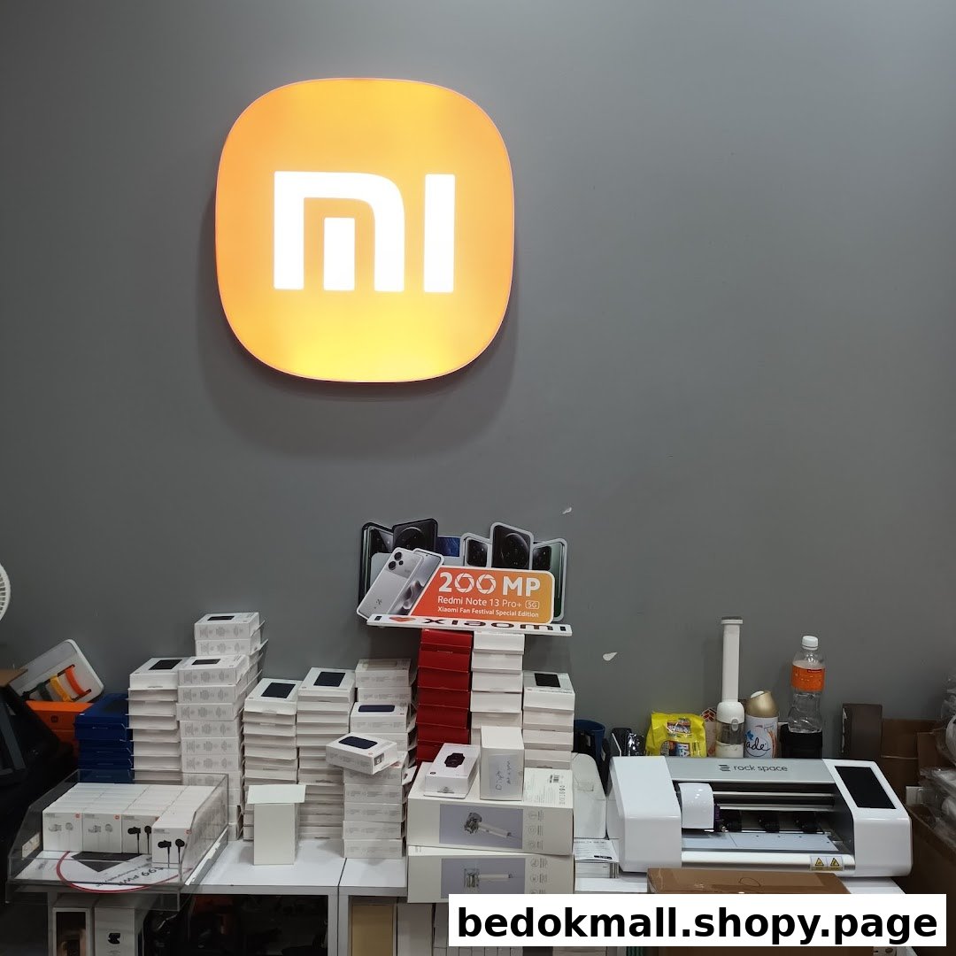 Interior shot of a Xiaomi shop with product boxes and equipment on a counter.