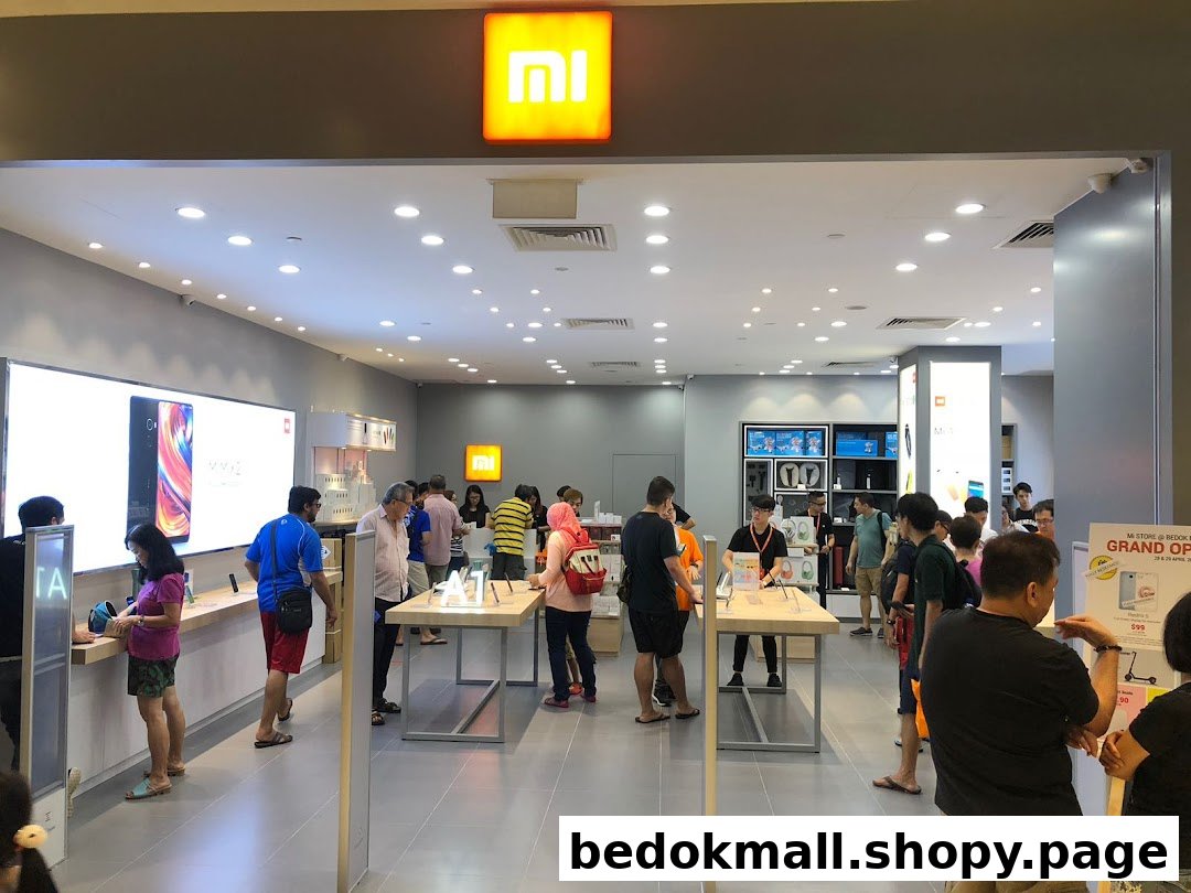 Customers browse products inside a brightly lit Xiaomi electronics store.