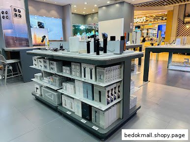 Interior view of a retail store with display tables and product boxes.
