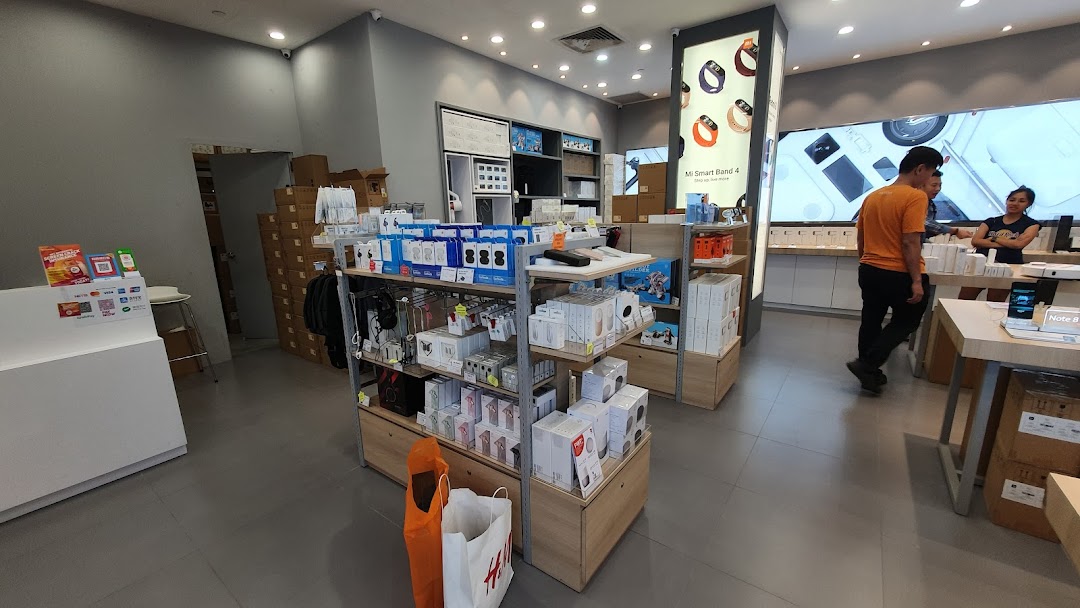 Interior view of a retail store with products on display and people.