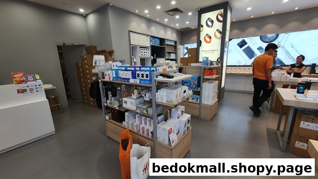 Interior view of a retail store with products on display and people.