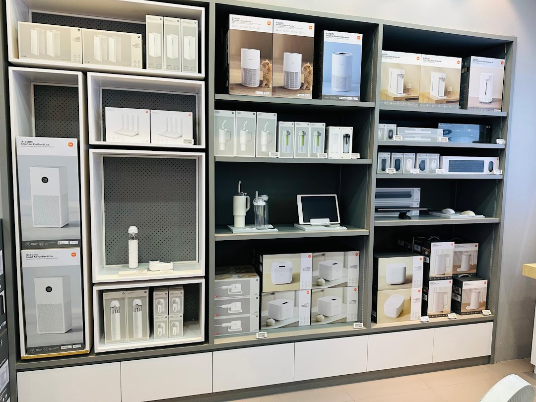 A retail display shelf showcasing various Xiaomi electronic products and their packaging.