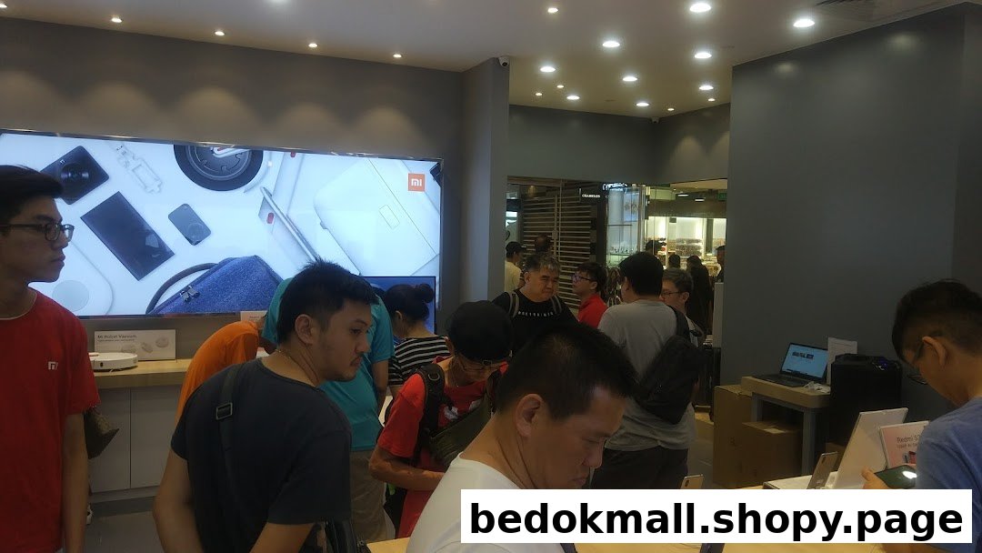 Customers browsing products inside a busy Xiaomi retail store.