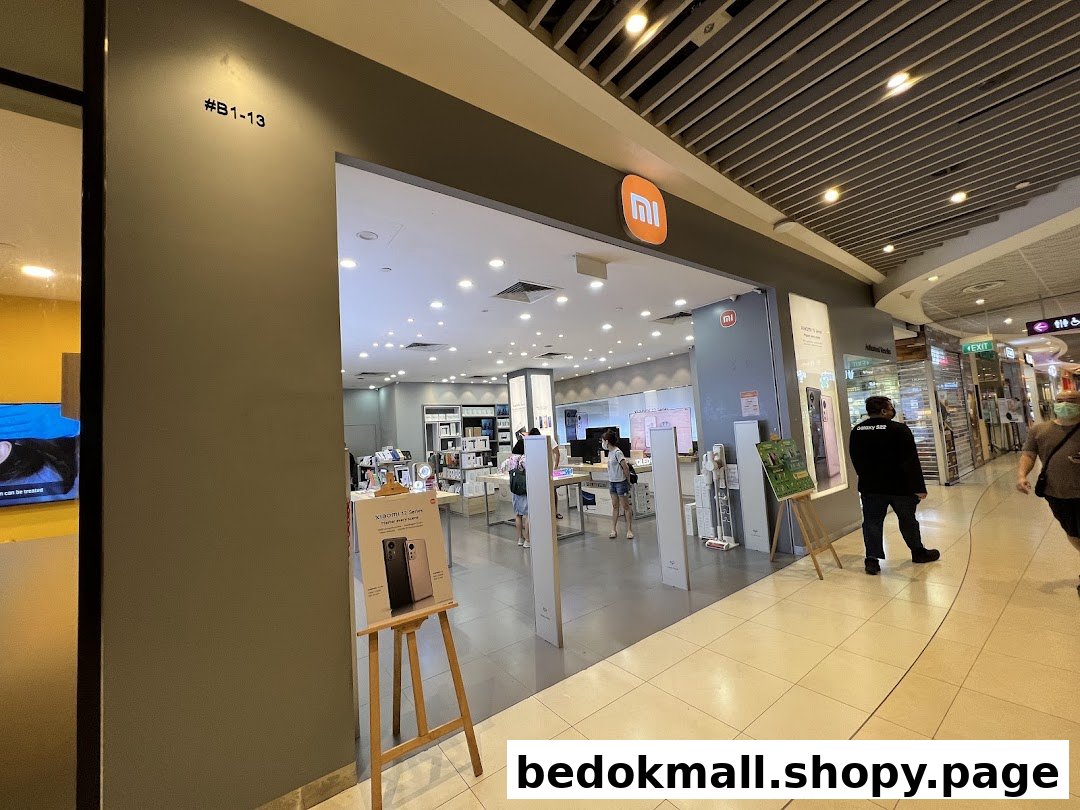 Entrance of a Xiaomi store in a mall with people walking by.