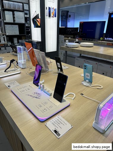 Interior view of a tech store with smartphones and electronics on display.