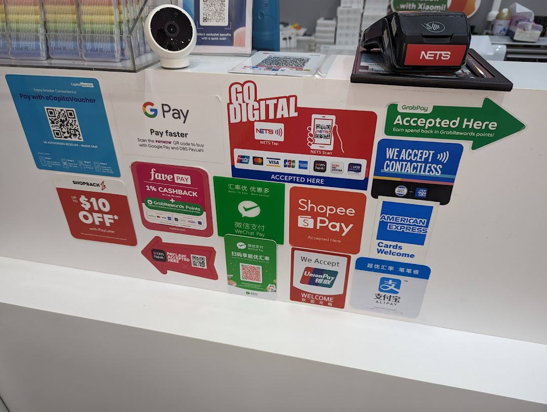 Counter displaying various accepted payment methods and a payment terminal.