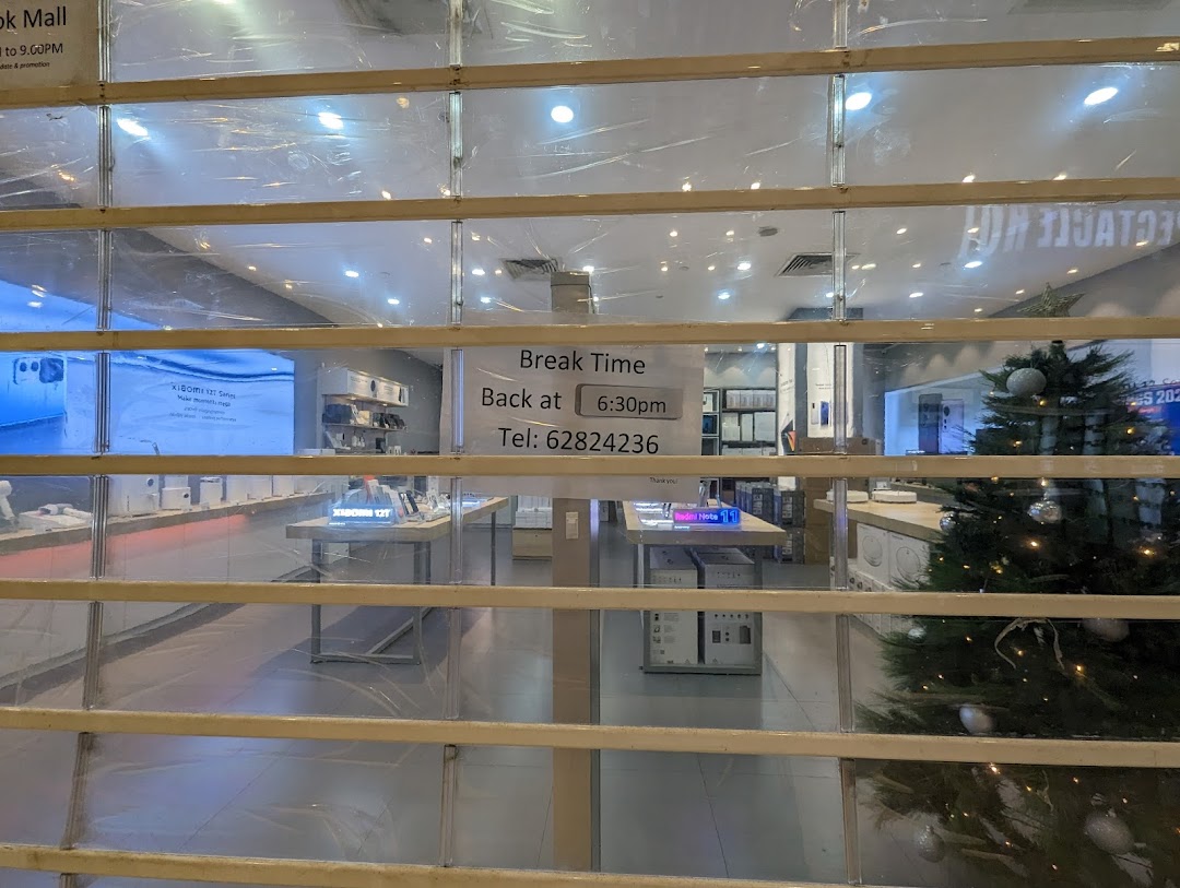 Shop entrance with security shutter down and 'Break Time' sign visible.