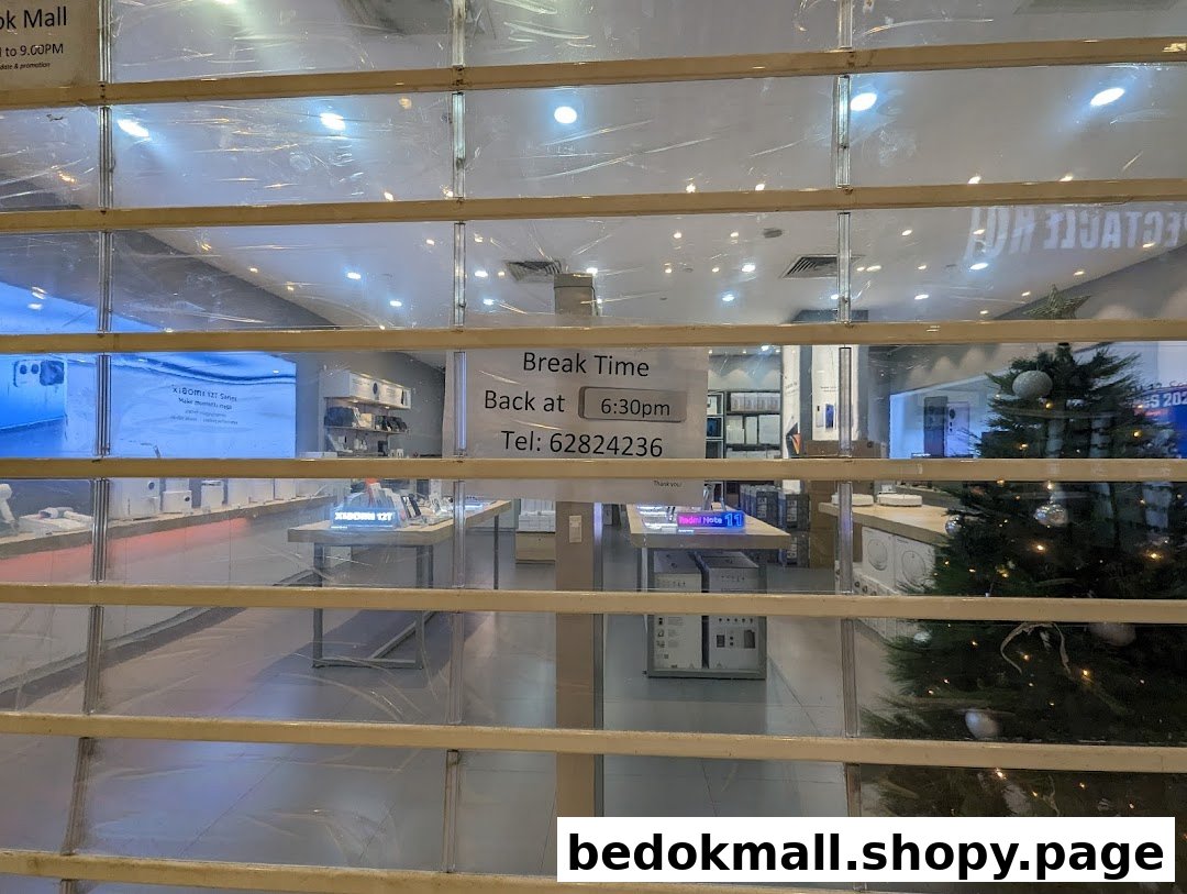 Shop entrance with security shutter down and 'Break Time' sign visible.