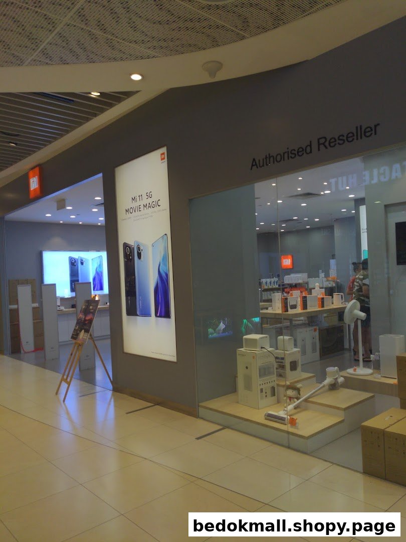 Xiaomi store front with large display and products visible through glass.