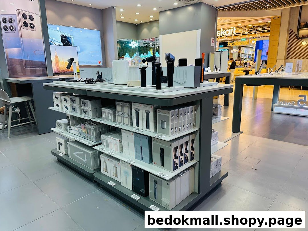 Interior view of a retail shop with product displays and large screens.