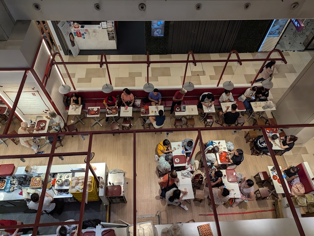 Overhead view of a busy cafe interior with many customers dining.