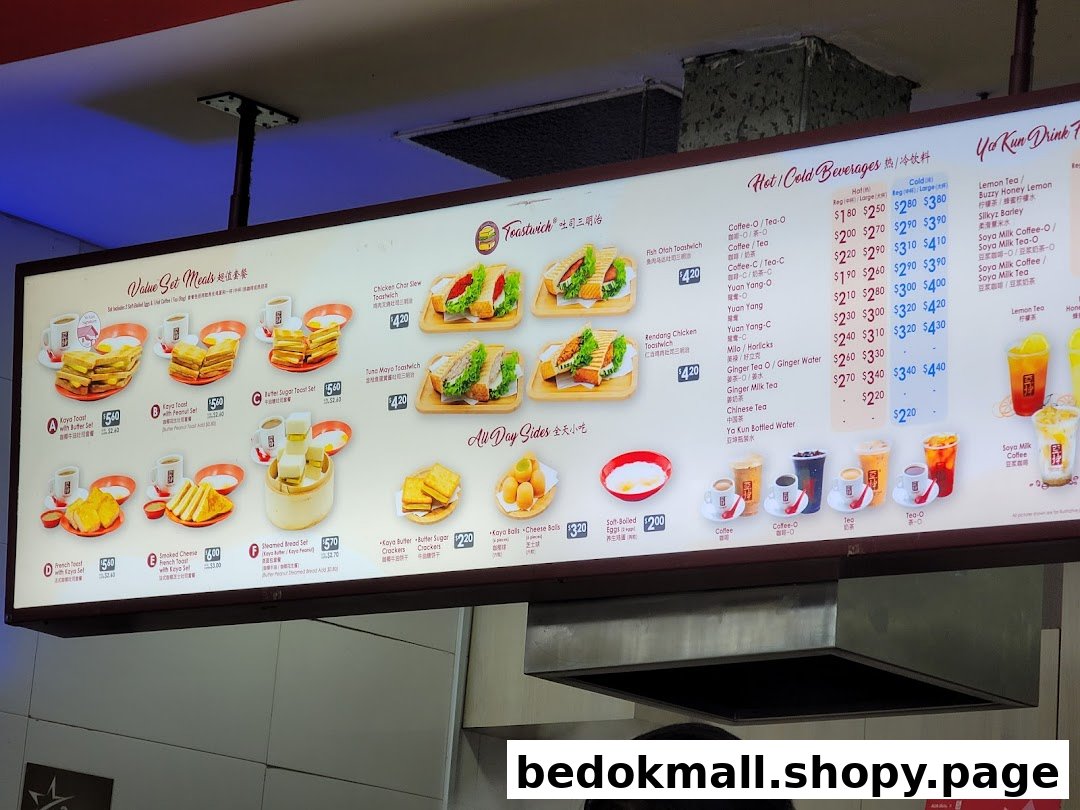 An illuminated menu board displaying food and drink items with prices.