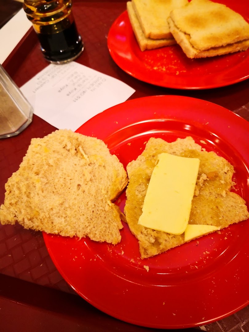 Two plates of toast with kaya and butter, a drink, and a receipt.