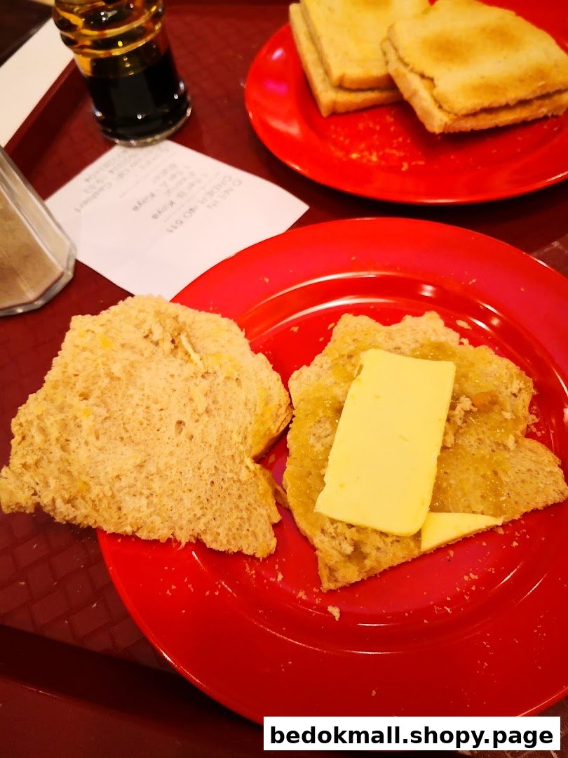 Two plates of toast with kaya and butter, a drink, and a receipt.