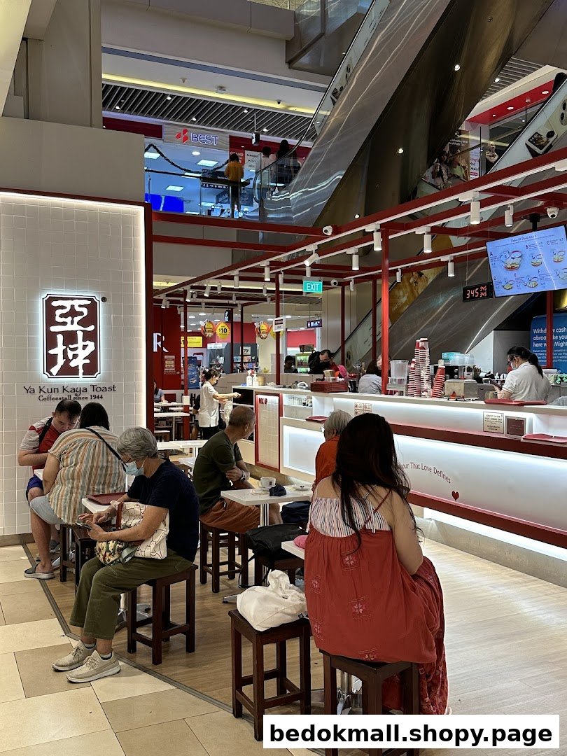 Customers seated inside a Ya Kun Kaya Toast shop with a counter.
