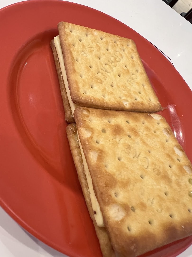 Two crackers with filling on a red plate.